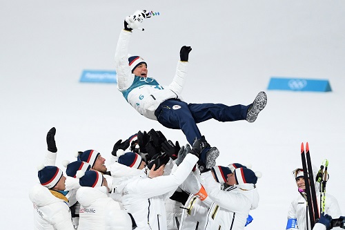 Biathlete Michal Krcmar is thrown into the air by his Czech teammates after winning the silver in the 10-kilometer sprint on February 11