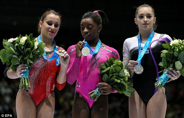 Simone Biles, centre, picks up gold in the floor exercise competition on her way to becoming the first black world champion 