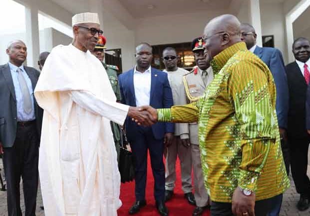 Nigeria's President(L) and his Ghanaian counterpart - guest(R) exchanging handshake 