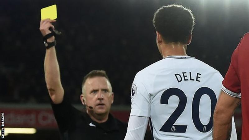 Dele Alli is booked by Jon Moss on Sunday