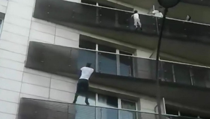 Paris 'Spiderman' climbs four-story building to save a dangling child
