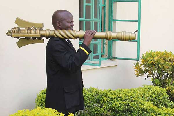 A county assembly orderly carrying a mace. Morning sittings at the Homa Bay County Assembly were on October 17, 2018 delayed for more than 30 minutes after unknown people took away the mace from the Speaker’s office. PHOTO | FILE | NATION MEDIA GROUP 