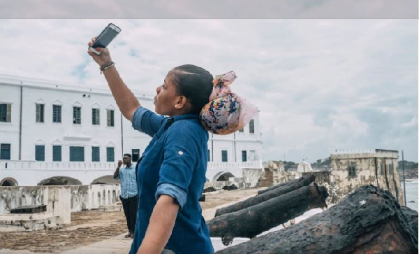 A tourist takes a selfie at Ghana’s Cape Coast Castle in August. (Natalija Gormalova/AFP/Getty Image