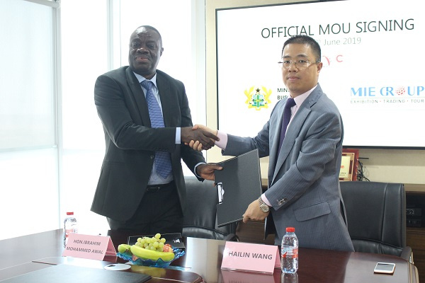Business Development Minister in a handshake with the Chairman of MIE Groups David Wang