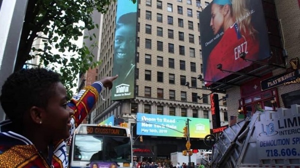 DJ Switch points to her face on a billboard