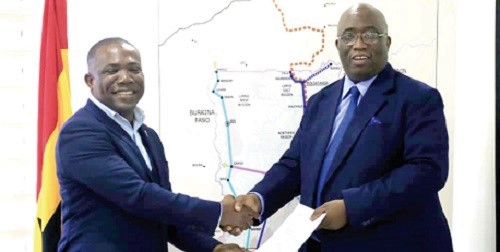 Mr Joe Ghartey (right), the Minister of Railways Development, exchanging the agreement with Mr Stanley R.K. Ahorlu after signing the MoU