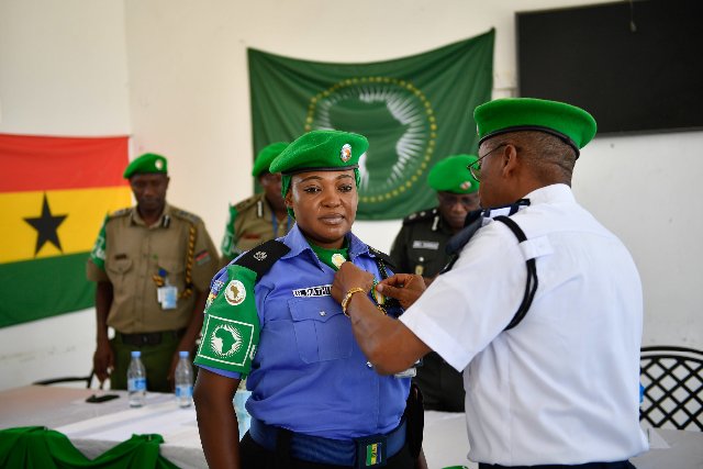 AMISOM Police, Chief of Staff, Rex Dundun, pinning a medal on a Police Officer during the medal parade ceremony