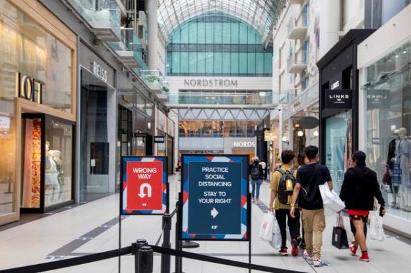 FILE PHOTO: People walk in the Eaton Centre shopping mall, as the provincial phase 2 of reopening from the coronavirus disease (COVID-19) restrictions begins in Toronto, Ontario, Canada June 24, 2020.