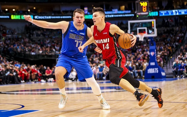 Nov 2, 2021; Dallas, Texas, USA; Miami Heat guard Tyler Herro (14) drives to the basket as Dallas Mavericks guard Luka Doncic (77) defends during the fourth quarter at American Airlines Center. Mandatory Credit: Kevin Jairaj-USA TODAY Sports