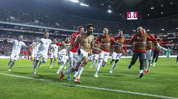 Serbia clinched an automatic berth in the 2022 World Cup finals after a 90th-minute header by half-time substitute Aleksandar Mitrovic gave them a comeback 2-1 win over Portugal in their Group A qualifier on Sunday.