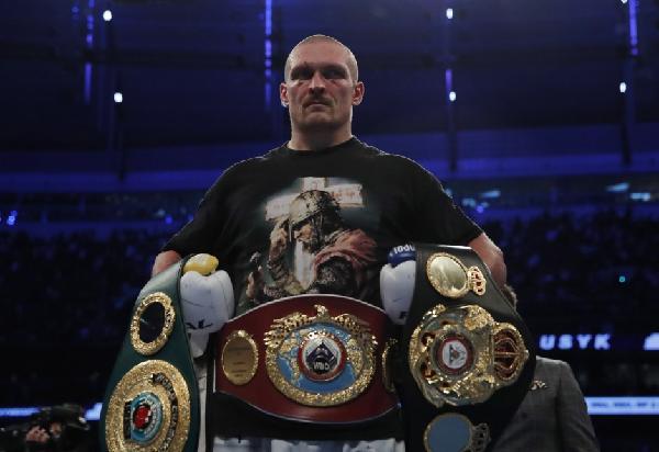 Oleksandr Usyk (centre) stunned Anthony Joshua at the Tottenham Hotspur Stadium on Saturday