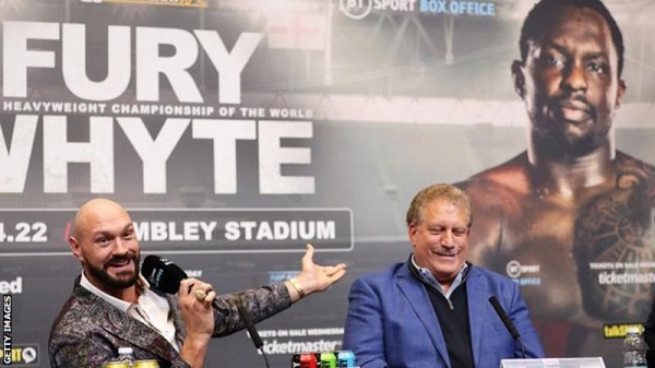 Tyson Fury points at Dillian Whyte's picture after he failed to show up for the pair's news conference