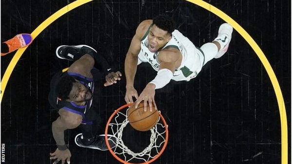 Bucks' Antetokounmpo (right) returned from a knee injury to score 20 points in the first game of the NBA Finals