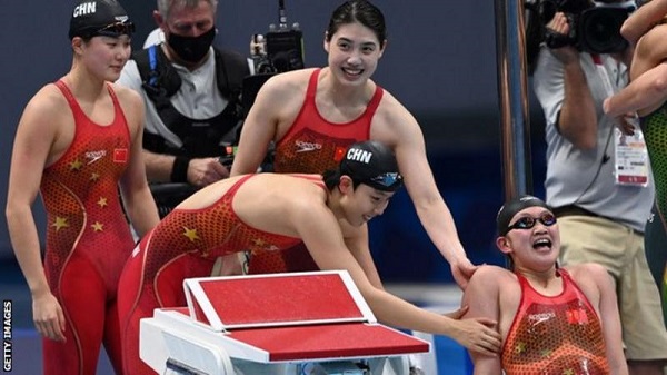 Junxuan Yang, Muhan Tang and Yufei Zhang of Team China react after winning the gold medal in the women's 4x200m freestyle relay final