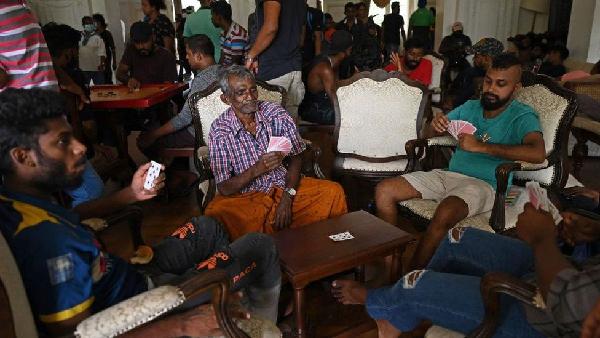 People play cards in the official residence of Sri Lanka's prime minister on Sunday