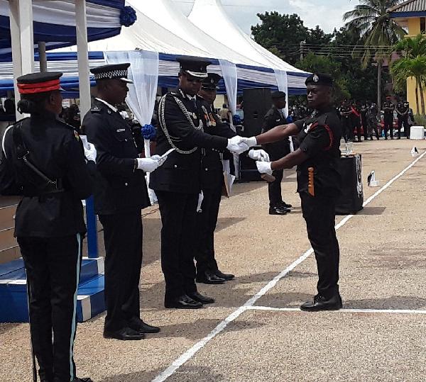 G/Sgt Kwaku Aduenin Boakye(right) receiving his award as the overall best under cadet from his father, COP Kofi Boakye. PICTURES BY EMMANUEL BAAH 