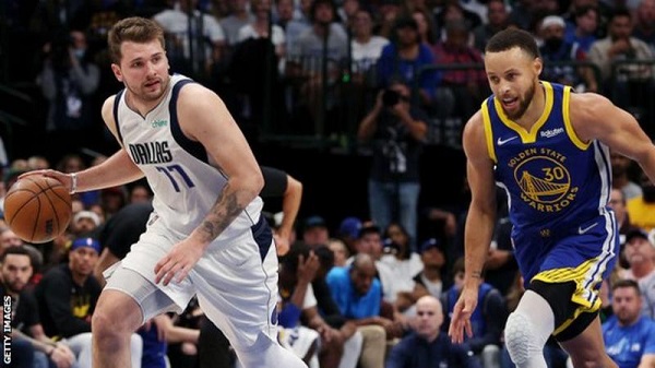 Doncic (left) put up 30 points while Golden State superstar Stephen Curry (right) scored 20