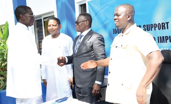 Justice Yonny Kulendi, Supreme Court Judge, in a handshake with Prof. Ato Duncan (left), CEO of COA Mixture Centre, after presenting a cheque for GH¢100,000 towards the Journalists Support Fund during the launch. With them are Abdourahamme Diallo (2nd from left) Representative, UNESCO to Ghana, and Albert Dwumfour (right), President of the GJA. Picture: EBOW HANSON