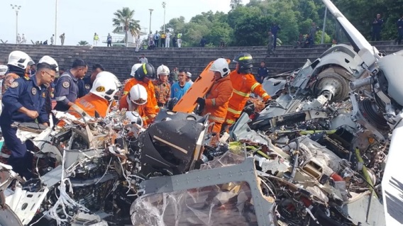 Perak Fire and Rescue DepartmentRescue personnel removing debris from the helicopter