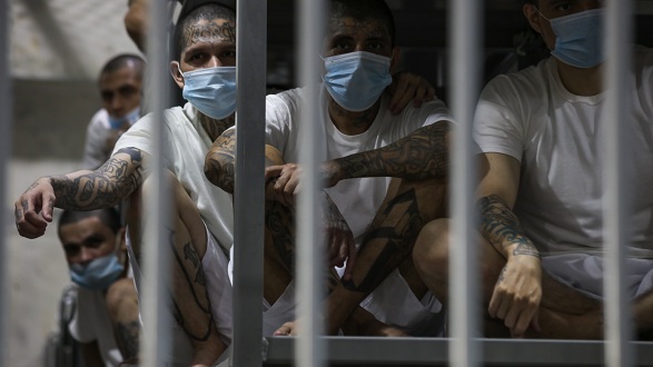 Alleged gang members sit in a prison cell at the Terrorism Confinement Center in El Salvador