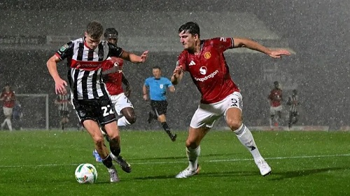 Grimsby's Cameron Gardner and Manchester United's Harry Maguire battle it out at Blundell Park