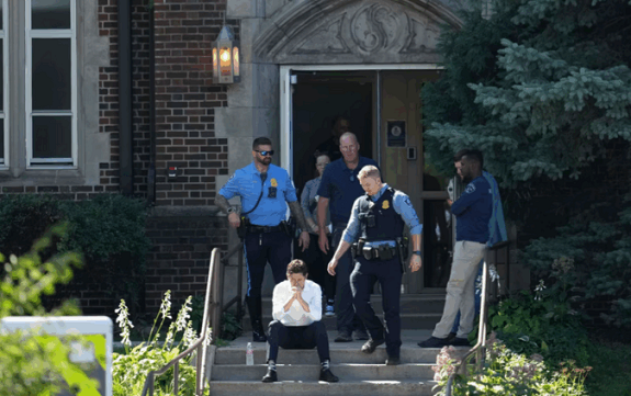 Minneapolis Mayor Jacob Frey sits on the steps of the Annunciation Church's school on Wednesday.