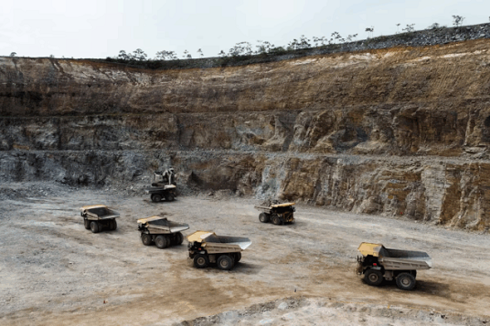 A drone view shows queued dump trucks at Gold Fields Mine in Tarkwa
