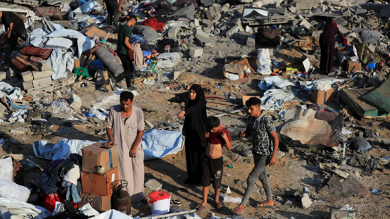 Palestinians inspect the site of Wednesday's Israeli strike on a house in Gaza City, 30 July 2026.