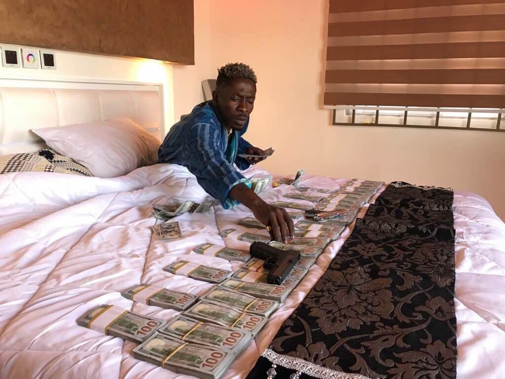 Shatta Wale flaunts millions of dollars on social media