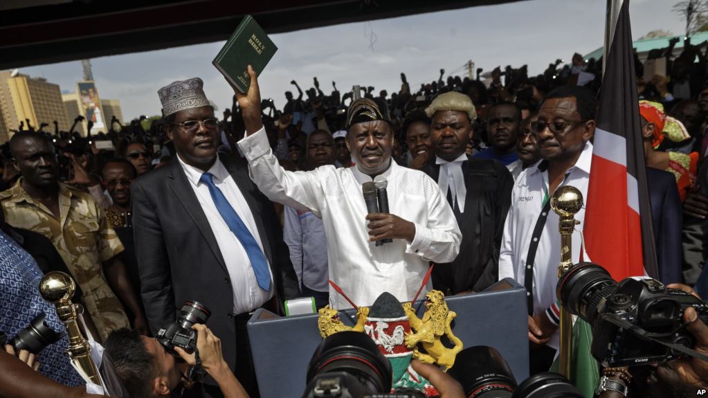 Mr Miguna, left, and opposition leader Raila Odinga at the mock ceremony in January