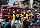 Traders sell goods along a busy street at Makola market in Accra