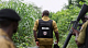 Anti-narcotics officers inspect the site of a suspected illegal drug laboratory in a dense forested area of western Nigeria