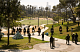 Federal agents ride on horseback through MacArthur Park in Los Angeles on Monday. Damian Dovarganes/AP