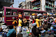 Traders sell goods along a busy street at Makola market in Accra
